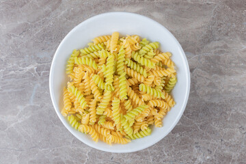 A bowl of mixed pasta , on the marble background