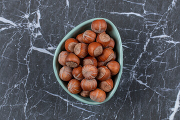 Top view of hazelnuts in blue bowl