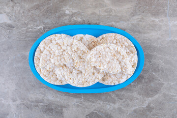 Some rice cakes on the board, on the marble background