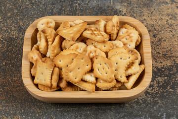 Variety of salted crackers in wooden bowl