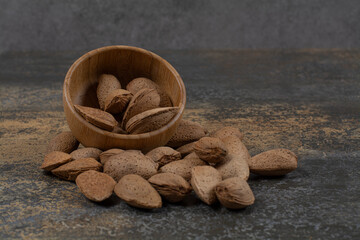Organic shelled almonds in wooden bowl