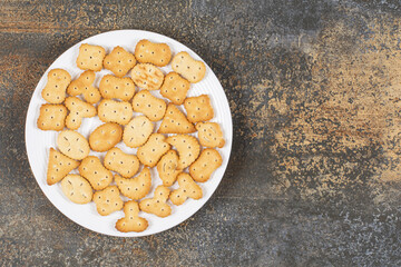 Various salted crackers on white plate