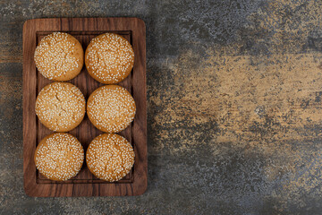 Cookies with sesame seeds on wooden plate