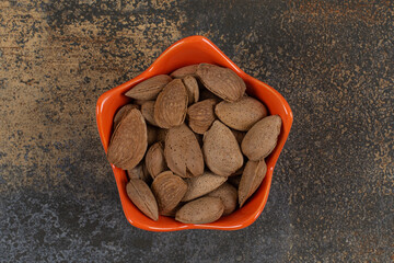 Organic shelled almonds in orange bowl - Powered by Adobe