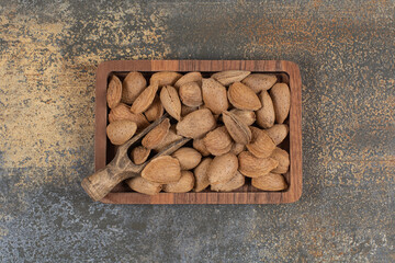 Organic shelled almonds on wooden plate