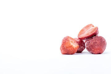 heap of frozen strawberries on white background with copy space 