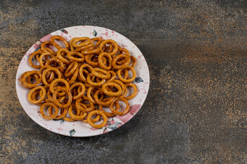 Salted pretzel rings on colorful plate