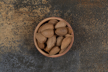 Organic shelled almonds in ceramic bowl