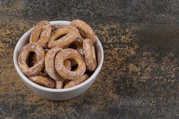 Pile of slated crackers in white bowl