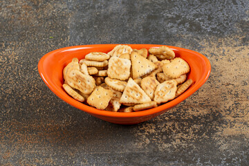 Variety of salted crackers in orange bowl