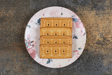 Pile of tasty biscuits on colorful plate