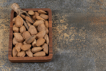 Organic shelled almonds on wooden plate