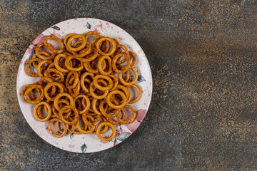 Salted pretzel rings on colorful plate