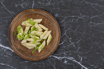 Penne pasta with vegetable sauce on wooden board