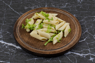 Close up photo of penne pasta with vegetable sauce