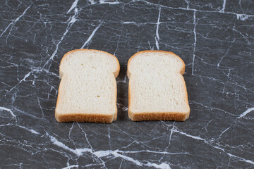 Fresh bread slices on grey background