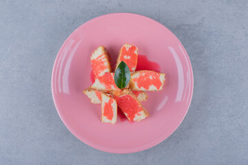 Top up view of fresh biscuit with sauce on pink plate