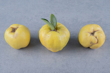 Fresh organic three apple quince on grey background