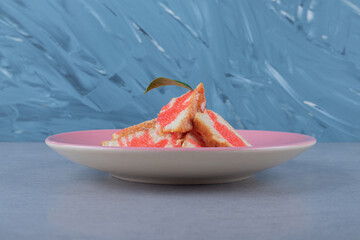 Close up photo of Homemade grapefruit cake on pink plate