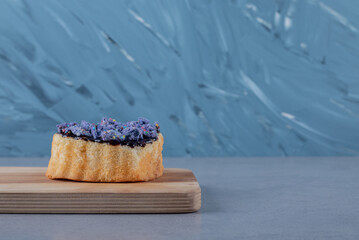 Fresh homemade cake with blueberry on wooden board