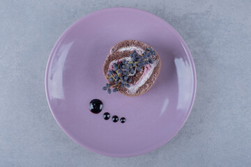 Creamy chocolate cake slice on purple plate