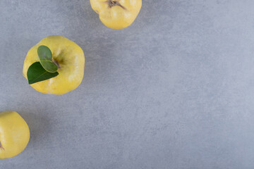 Ripe golden yellow quince fruits on table . Organic fruits on grey background