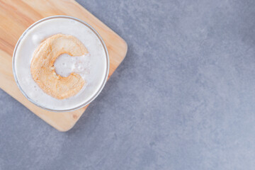 Close up photo of Freshly made caramel milk shake on wooden board