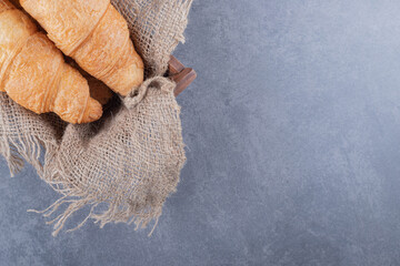 Obraz na płótnie Canvas Close up photo of two freshly baked French croissant