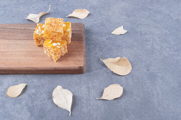 Yellow traditional turkish delight (rahat lokum) with peanuts on wooden board