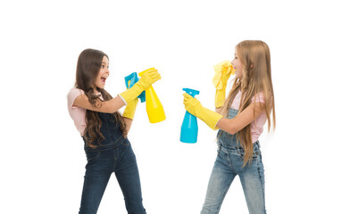 Cleaning products that work. Little girls spraying each other from bottles while doing house work. Happy small cleaners having fun during cleaning work. All kinds of cleaning work for home