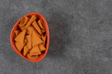 Triangle shaped crackers in orange bowl