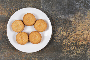 Yummy cookies filled with cream on white plate