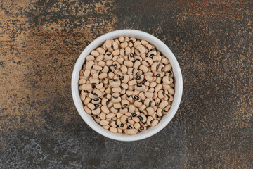 Pile of raw white beans in white bowl