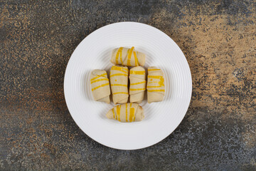 Bunch of creamy biscuits on white plate