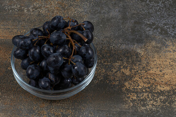 Fresh black grapes in glass bowl