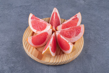 Fresh Grapefruit slices on wooden board