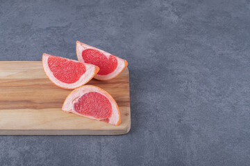 Close up photo of Fresh Grapefruit slices on wooden board