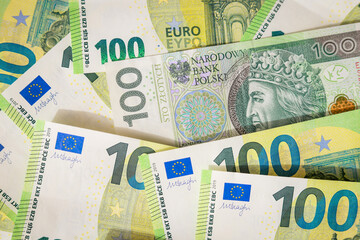 Euro banknotes and 100 polish zloty wallpaper. Close up of money. Wealth concept, free trade, business concept and inflation in Europe