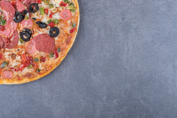 Freshly baked pepperoni pizza on grey background
