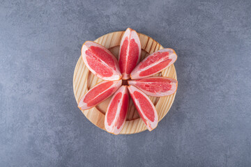 Top view of Fresh Grapefruit slices on wooden board