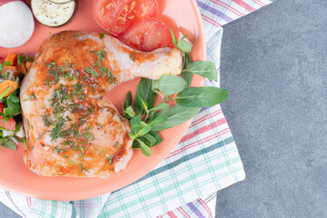 Marinated chicken and sliced vegetables on orange plate