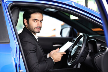 Businessman connecting car with her tablet and app using wifi. using online map or GPS navigation before driving.