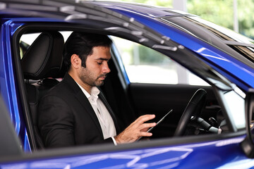 Businessman connecting car with her tablet and app using wifi. using online map or GPS navigation before driving.