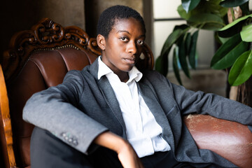 Portrait of african business woman sitting on couch in the office