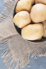 Bunch of potatoes in metal mug with burlap