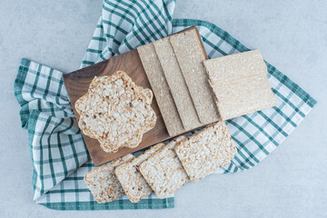 Rice cakes mixed around a box on towel, on the marble background