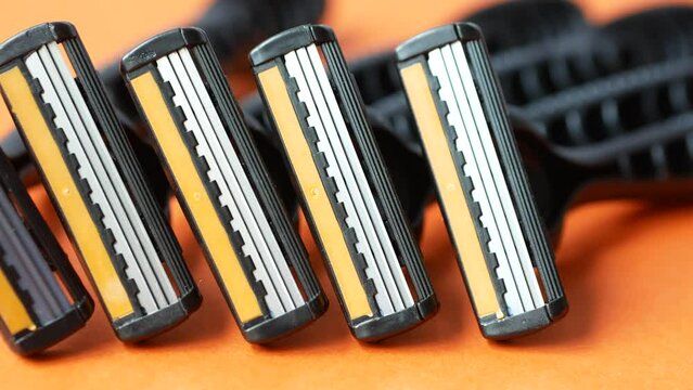 close up of razors on orange background 