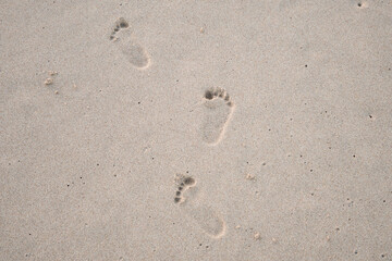 Fototapeta na wymiar Kids footprint in sand