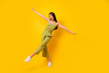Full length portrait of gorgeous glad thai person dance chilling good mood isolated on yellow color background