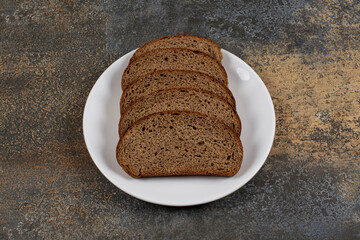 Several slices of rye bread on white plate